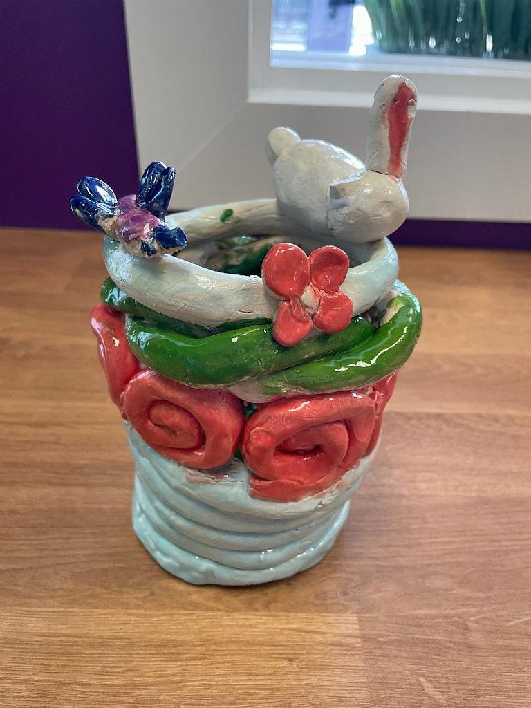 ceramic blue, orange and green coil pot with a blue and purple butterfly